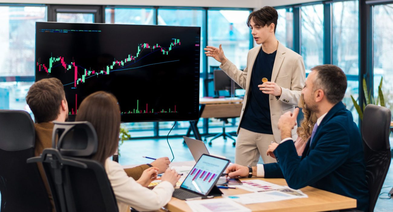 young-worker-leading-business-meeting-about-cryptocurrencies-office-2 young-worker-leading-business-meeting-about-cryptocurrencies-office-2